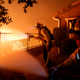 Los Angeles City firefighters battle the Saddleridge fire near homes in Sylmar, California.